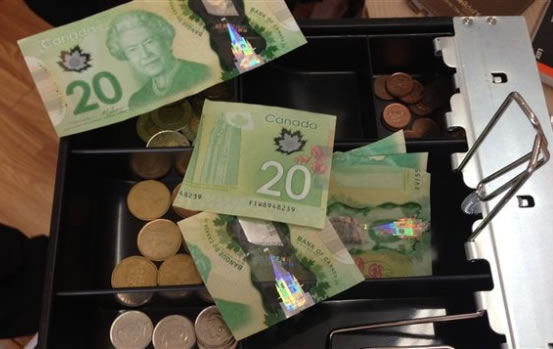 demi Canadian dollar bills cut-in-half